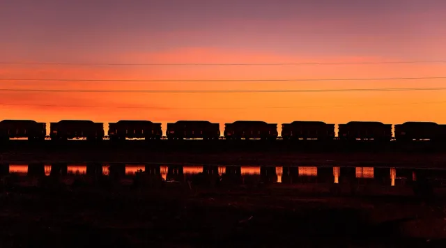 Train on the horizon with a beautiful sunset
