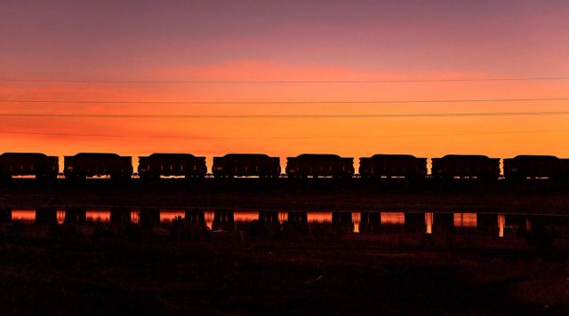 Train on the horizon with a beautiful sunset