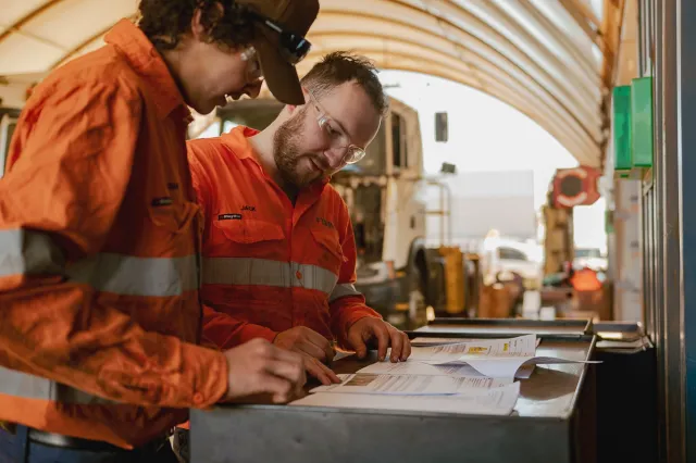 Finmec employees reading documentation