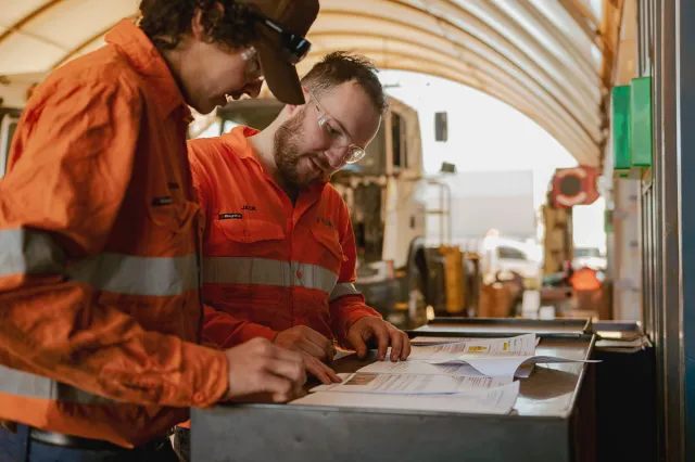 Finmec employees reading documentation