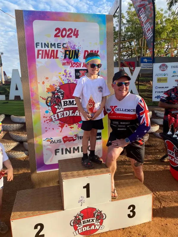 1st Place Bmx rider on the podium with his thophy