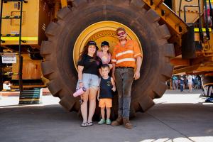 Family posing infront of a Cat Loader