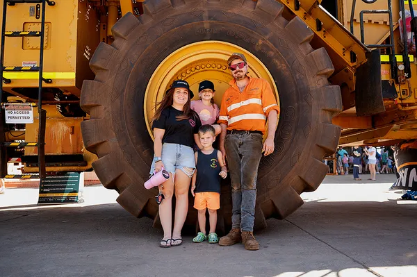 Family posing infront of a Cat Loader